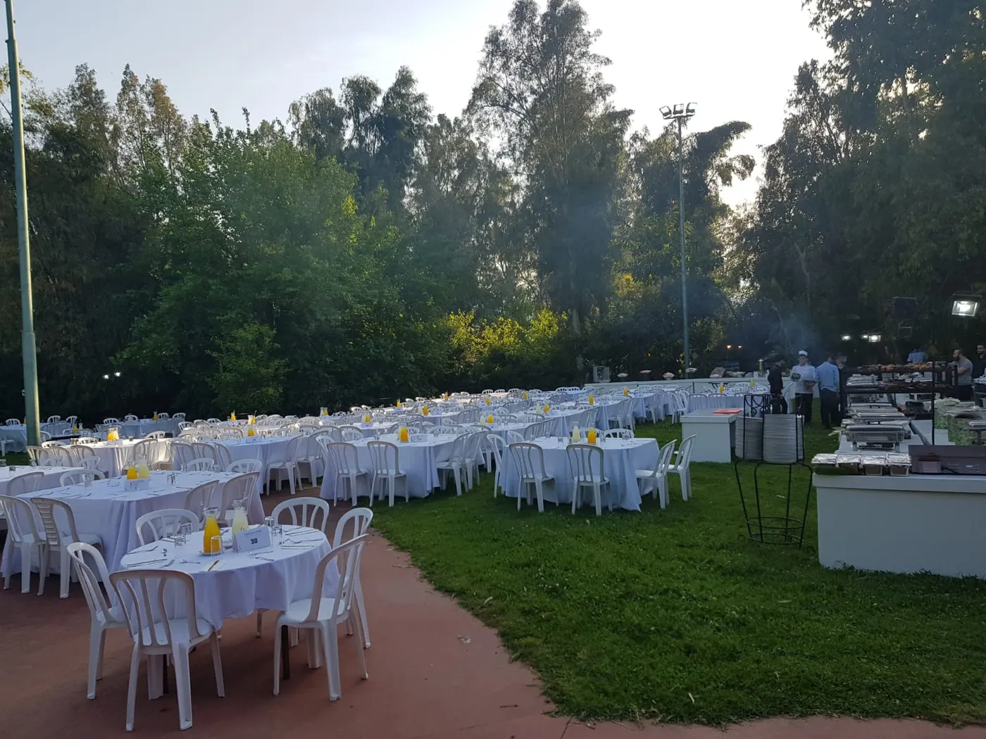 Tables set on a lawn for an outdoor event